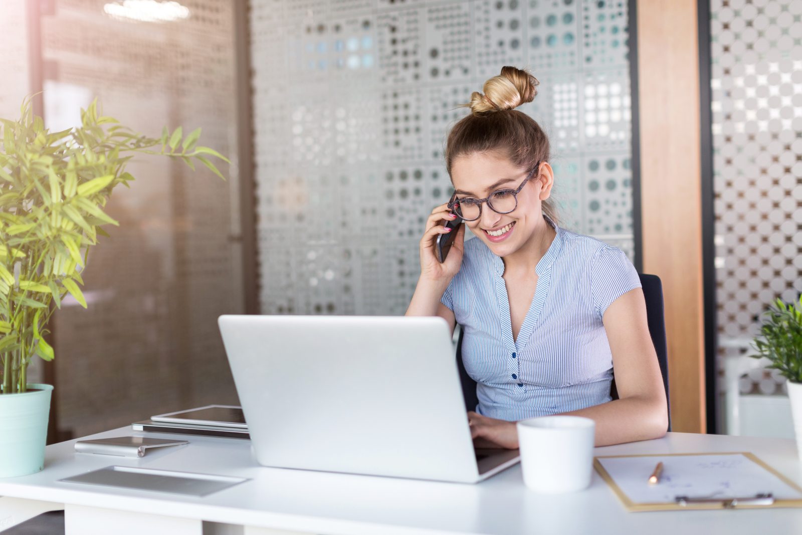 Young business woman working on laptop in office